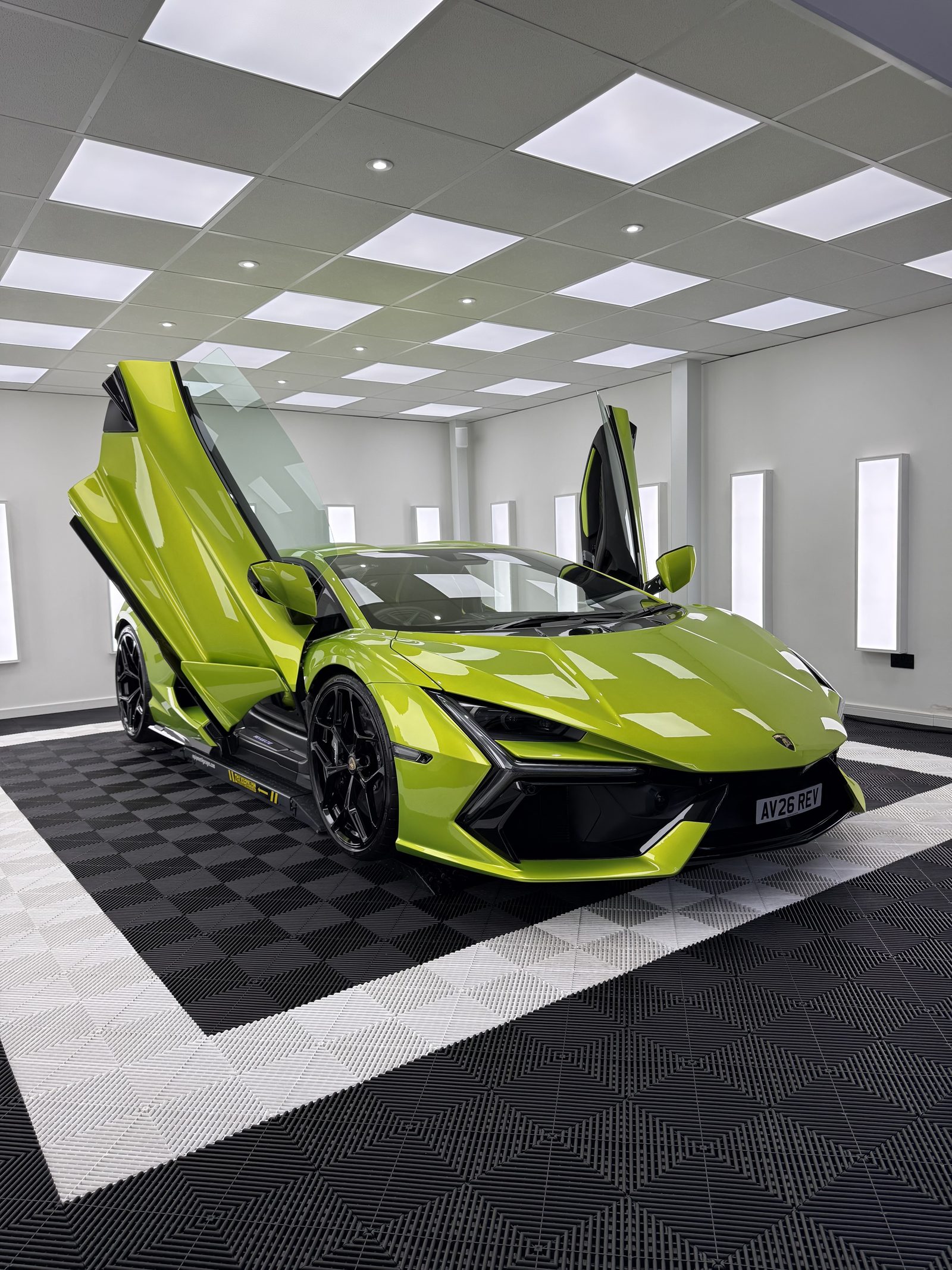 Verde green Lamborghini Revuelto with scissor doors up in the Elevate Detailing UK studio in Exeter